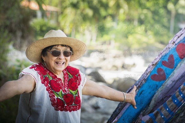 Hispanic woman smiling on beach