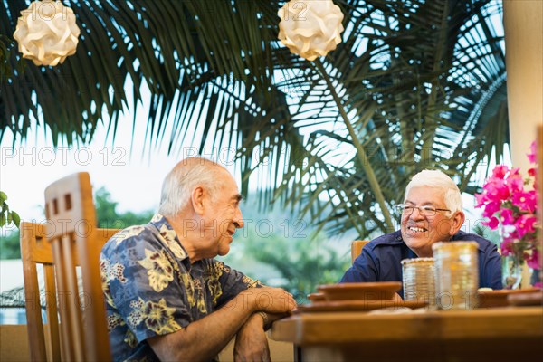 Hispanic men eating together in restaurant