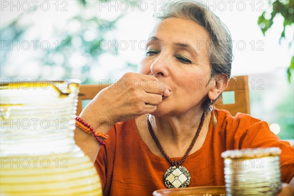 Hispanic woman eating in restaurant