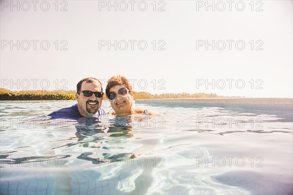 Mother and son smiling in swimming pool