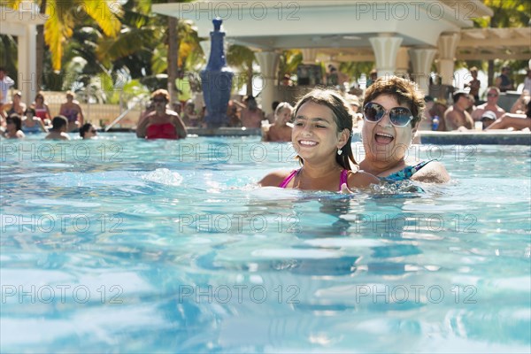 Grandmother and granddaughter playing in swimming pool