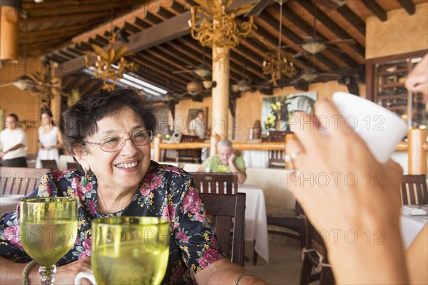 Older woman laughing in restaurant