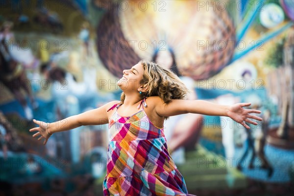 Mixed race girl dancing near urban rural