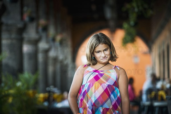 Hispanic girl making a face outdoors