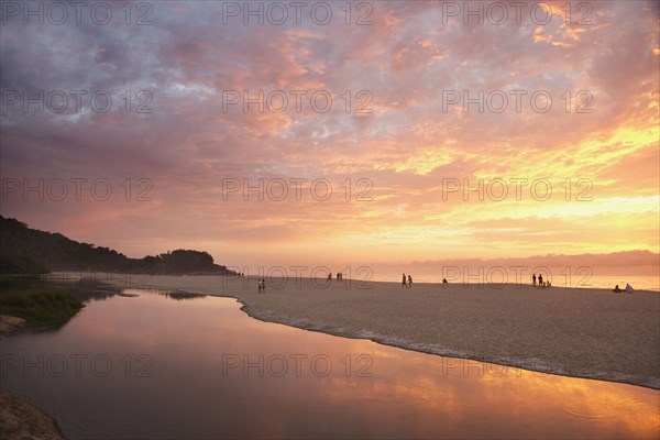 Sunset over still pool at beach