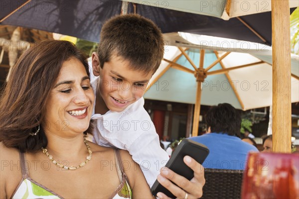 Mother and son using cell phone