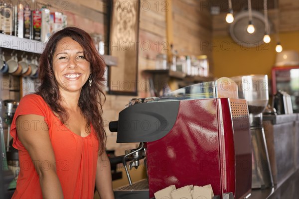 Smiling Hispanic woman working in coffee shop