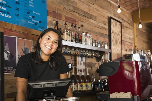 Hispanic woman working in coffee shop