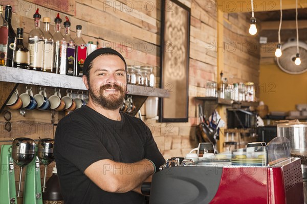 Hispanic man working in coffee shop