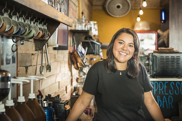 Hispanic woman working in coffee shop