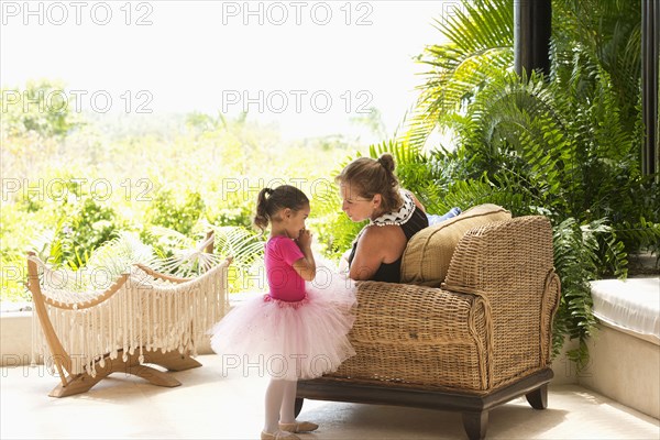 Mother talking to daughter in tutu