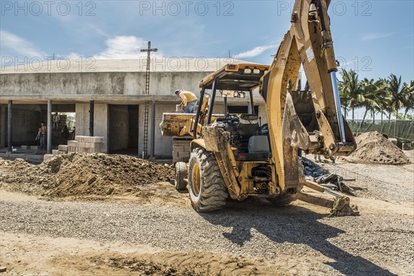 Hispanic construction worker on bulldozer at construction site