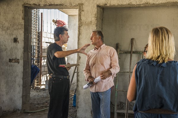 Architects talking at construction site