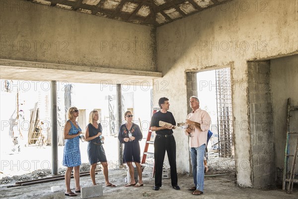 Caucasian architects talking at construction site