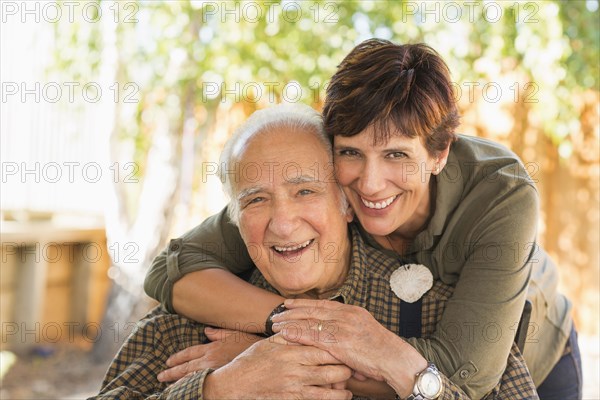 Hispanic father and daughter hugging