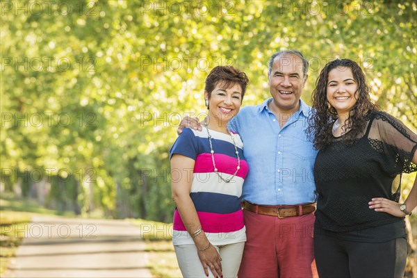 Hispanic family smiling together outdoors