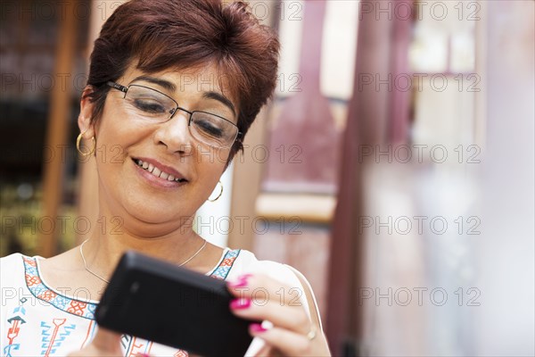 Hispanic woman using cell phone