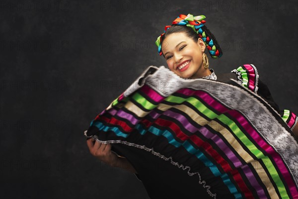 Hispanic teenage girl dancing in Jallisco Folkloric dress