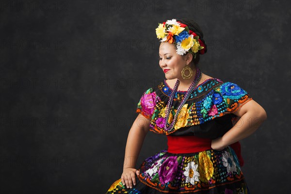 Hispanic woman dancing in Chiapas Folkloric dress