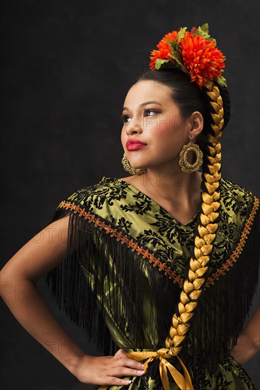 Hispanic teenage girl dancing in Puebla Folkloric dress