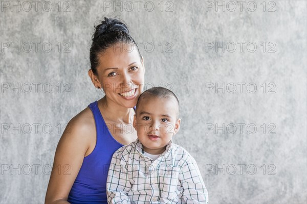 Smiling Hispanic mother and son