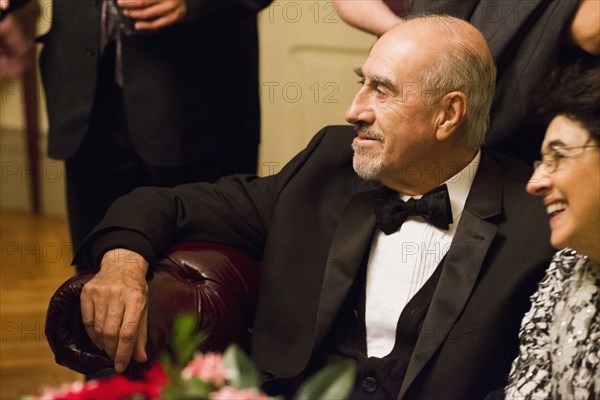 Hispanic family in formal wear sitting at wedding