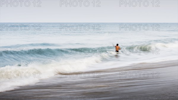 Man swimming in waves