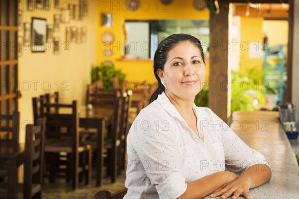 Smiling woman at counter in restaurant