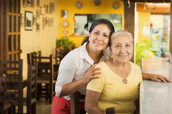 Smiling women at counter in restaurant