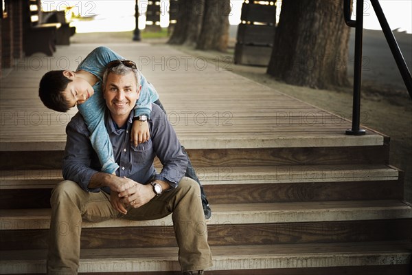 Father and son playing on porch