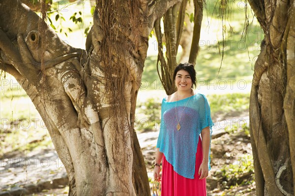 Hispanic woman smiling in jungle