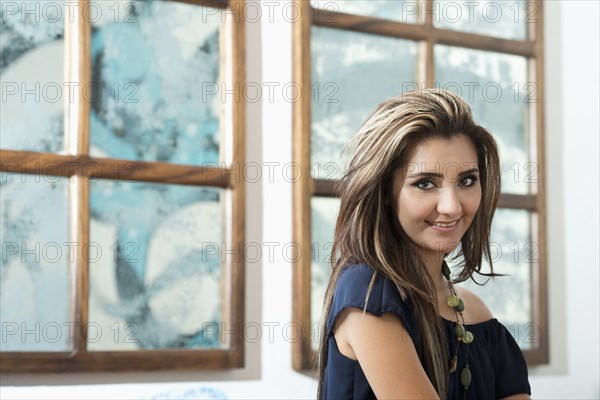 Hispanic woman smiling indoors