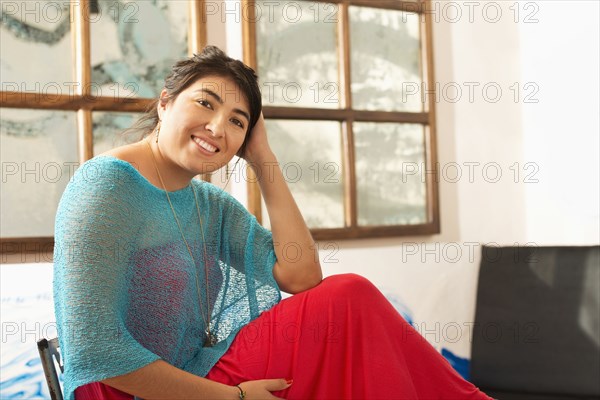 Hispanic woman smiling indoors