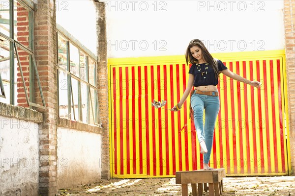 Hispanic woman balancing on platform