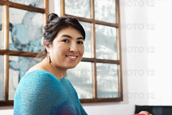 Hispanic woman smiling in cafe