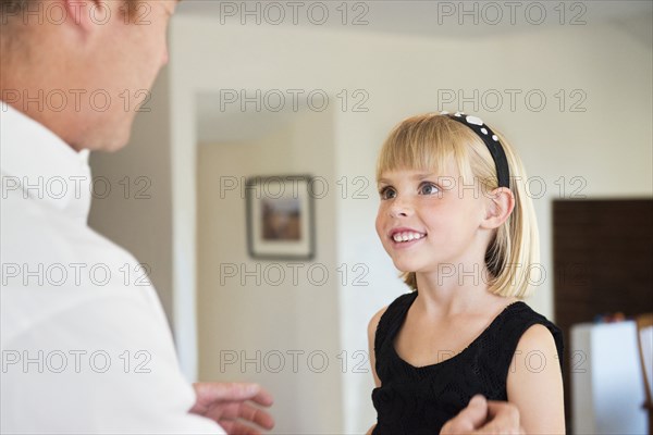 Caucasian father and daughter talking in living room