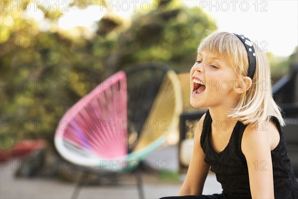 Caucasian girl shouting in backyard