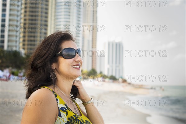 Hispanic woman standing on urban beach