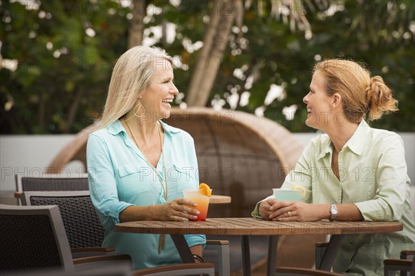 Women having cocktails on restaurant patio