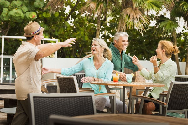 Couples hugging on restaurant patio