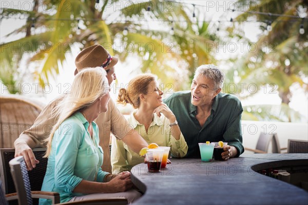 Couples having cocktails at patio bar