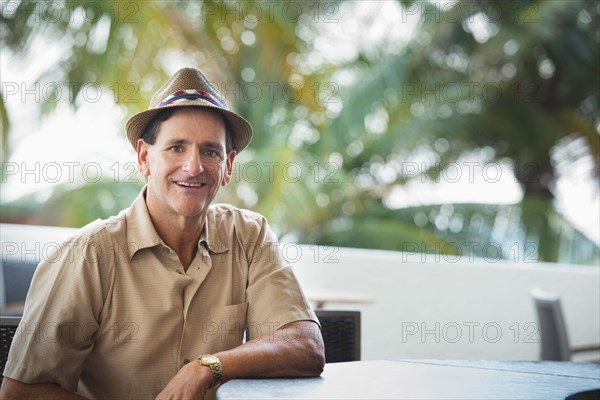 Caucasian man sitting at patio bar