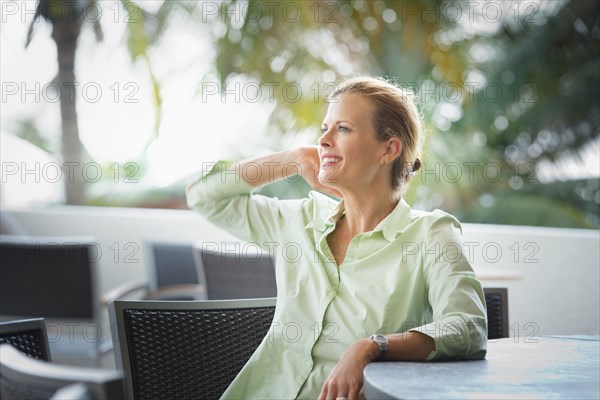 Woman sitting at patio bar