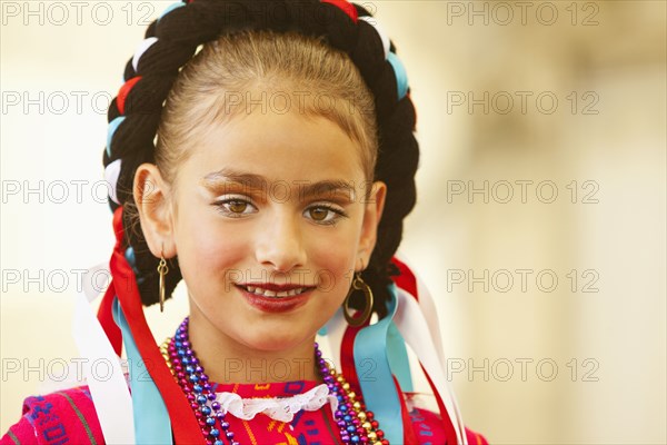 Mixed race girl wearing traditional makeup and dress