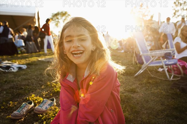 Mixed race girl laughing in park