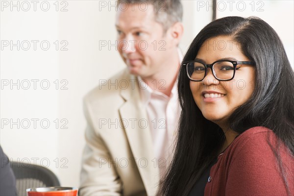 Businesswoman smiling in office meeting