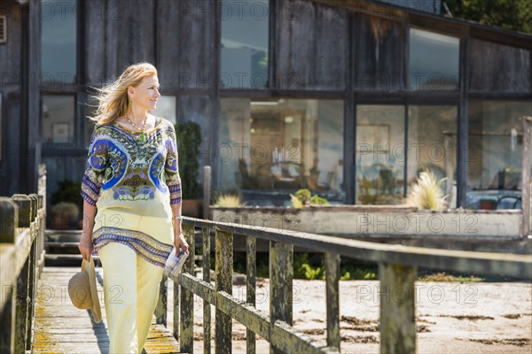 Caucasian woman walking on wooden walkway