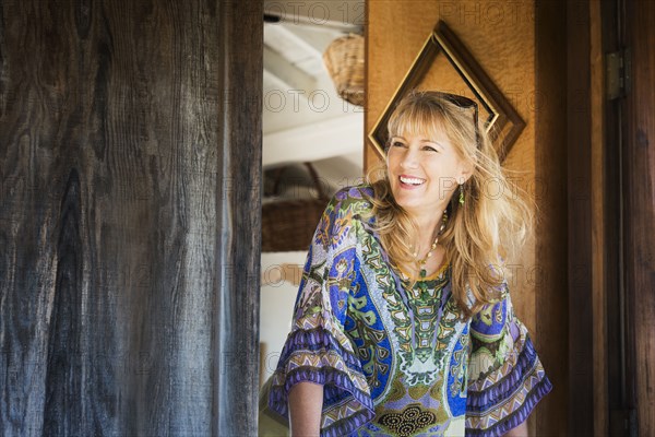 Caucasian woman smiling in doorway