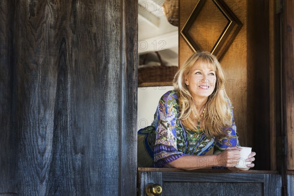 Caucasian woman smiling in doorway