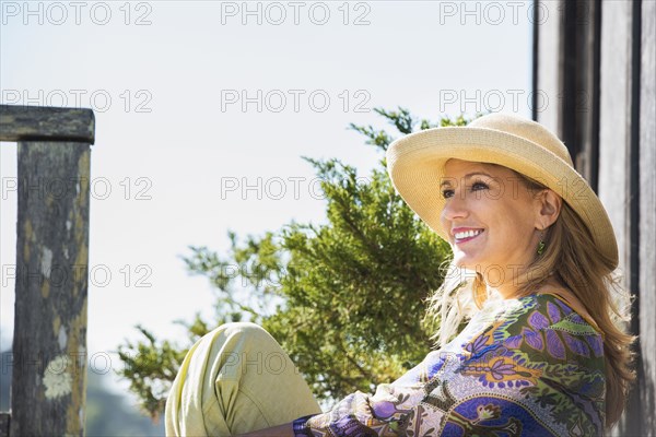 Caucasian woman relaxing on porch